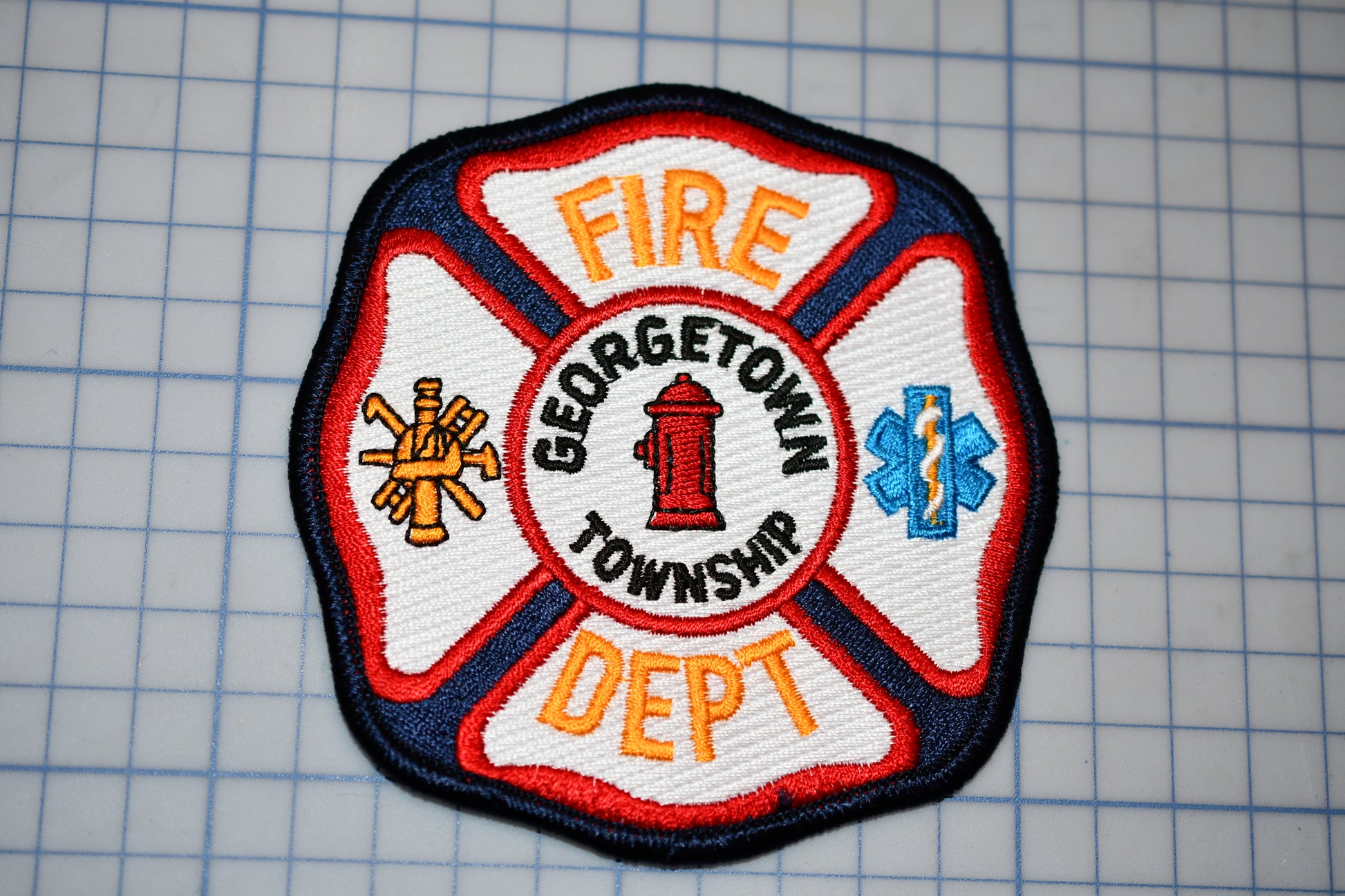 a fire department patch on a cutting board