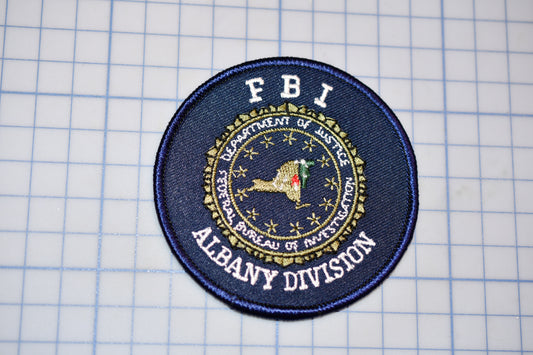 a patch with the department of albany division on it