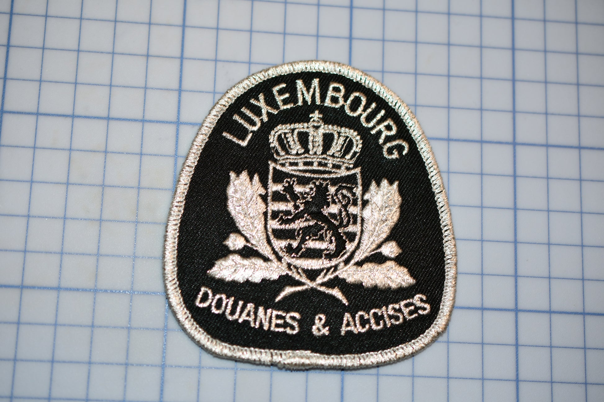 a black and white patch with a crown on it