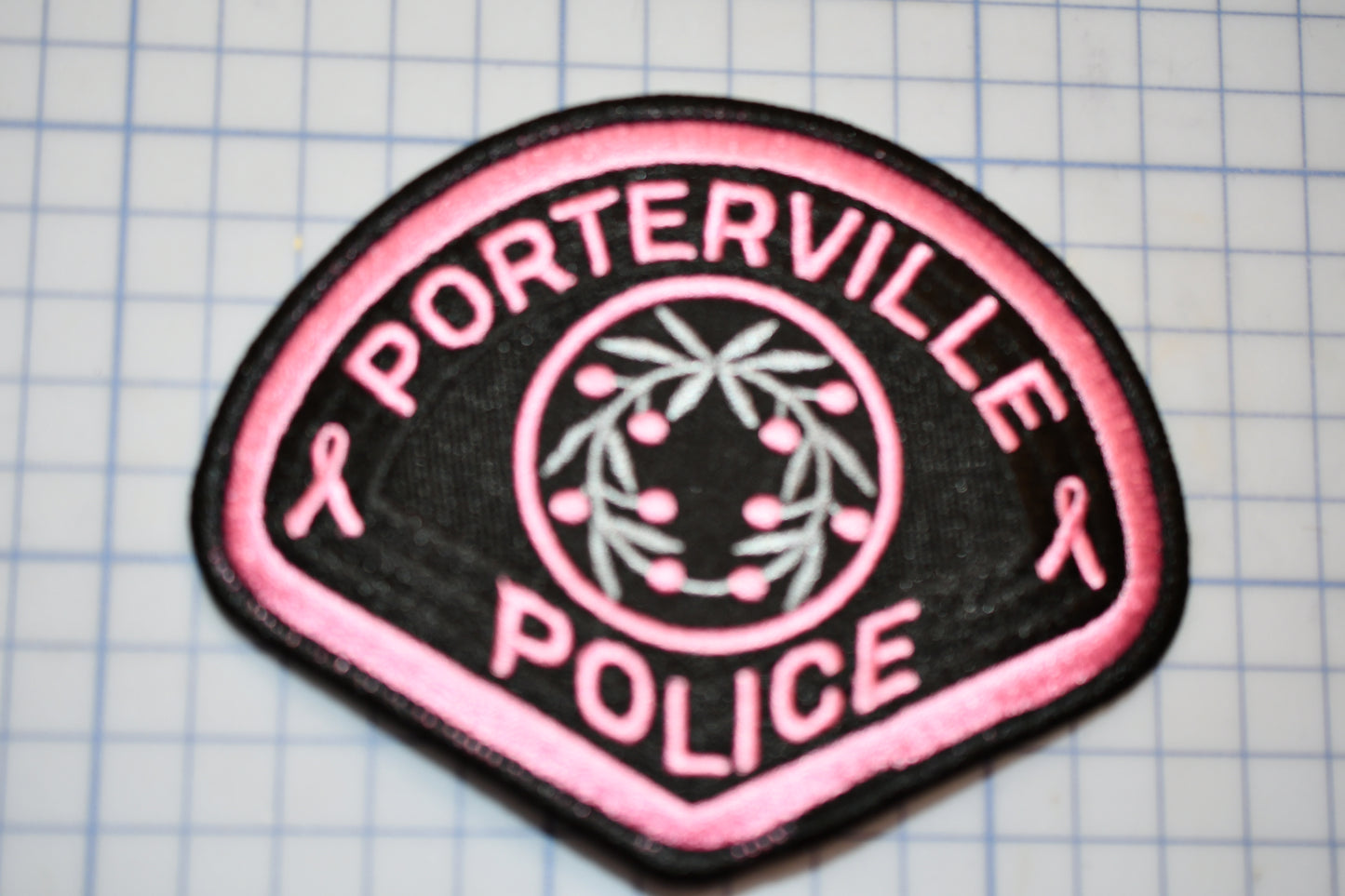 a pink and black patch that says portterville police