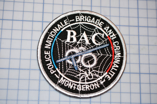 a black and white patch with a red, white, and blue logo