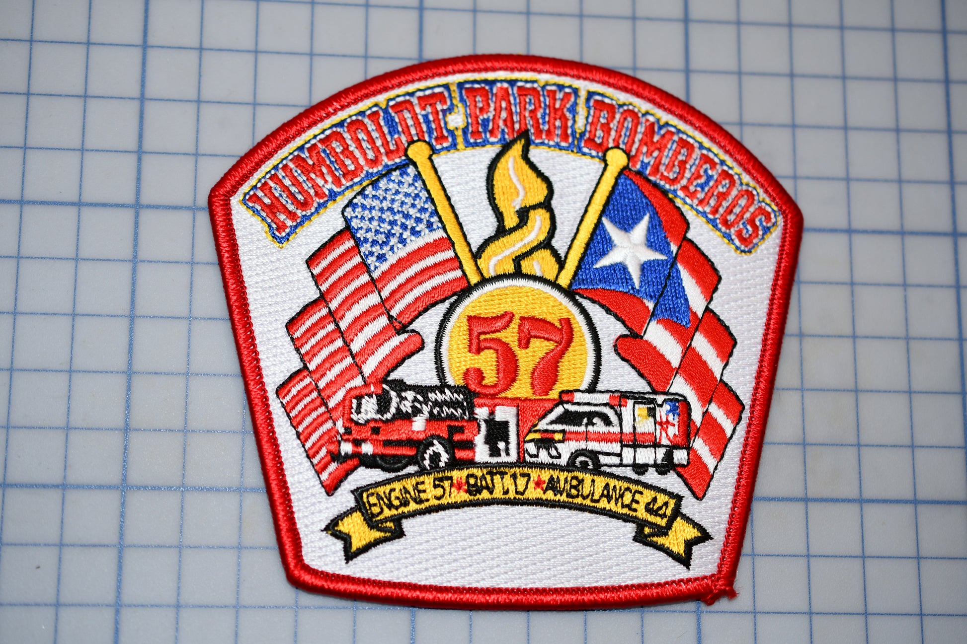 a patch with a fire truck and american flags on it