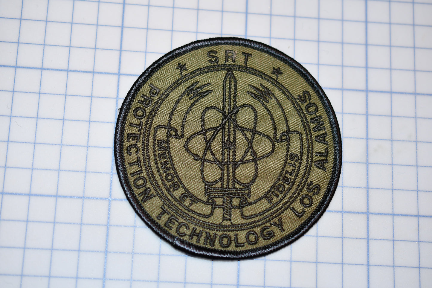 a patch with a science emblem on it