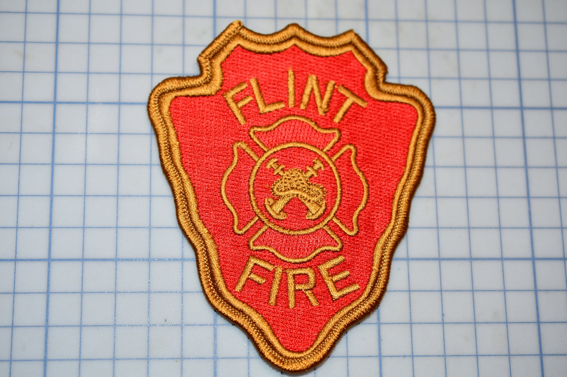 a fire department patch on a cutting board