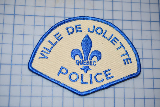 a police patch with a fleur de joliette on it