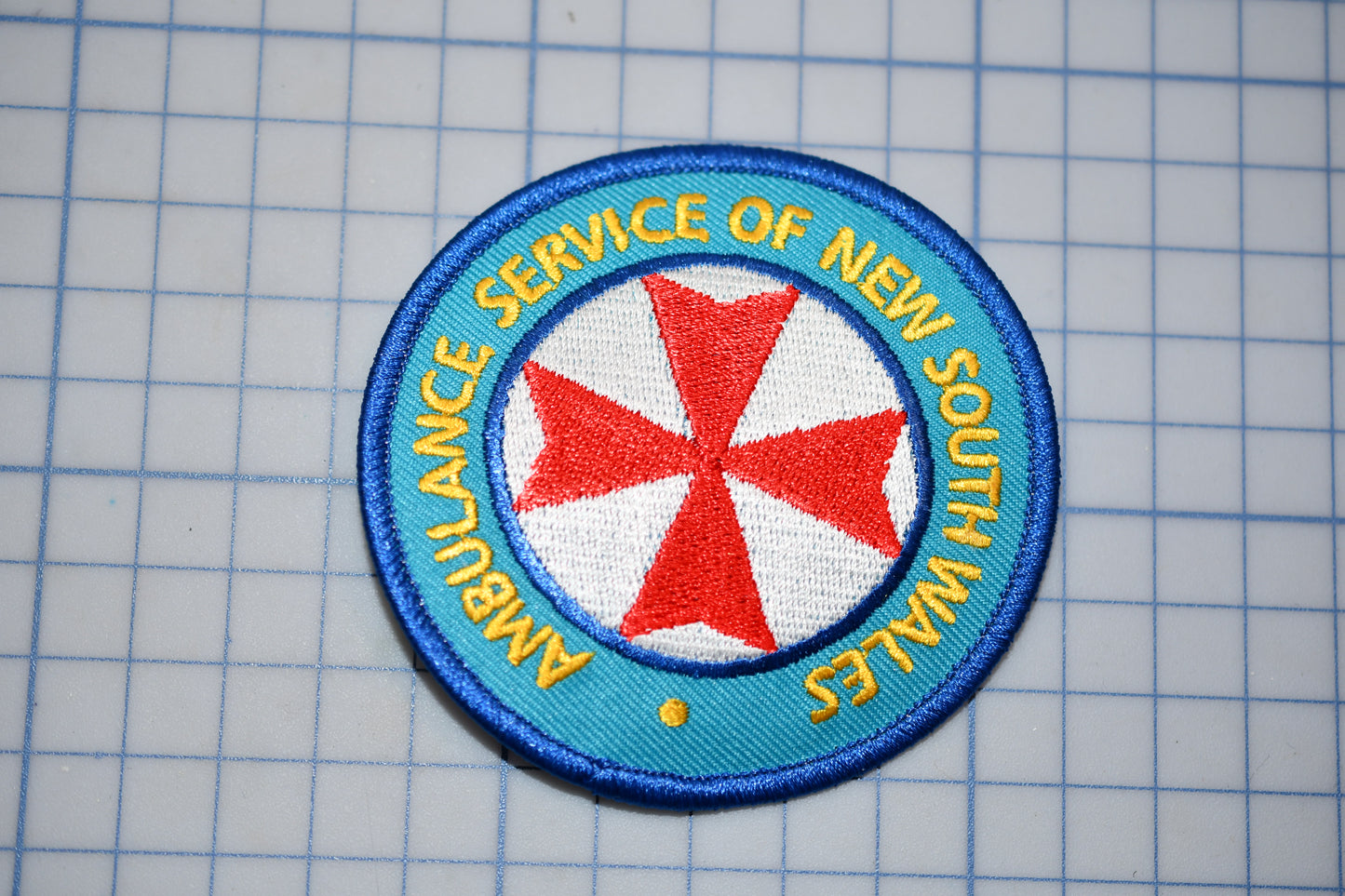 a patch with a red and blue cross on it