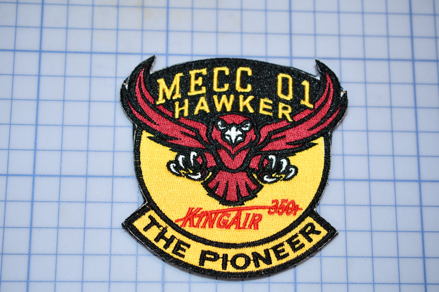 a patch with a picture of a hawk on it