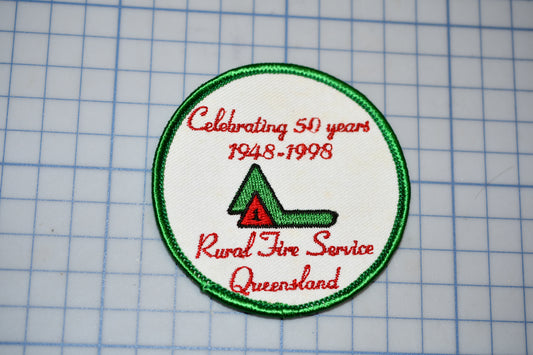 a green and white patch with a red and green arrow on it