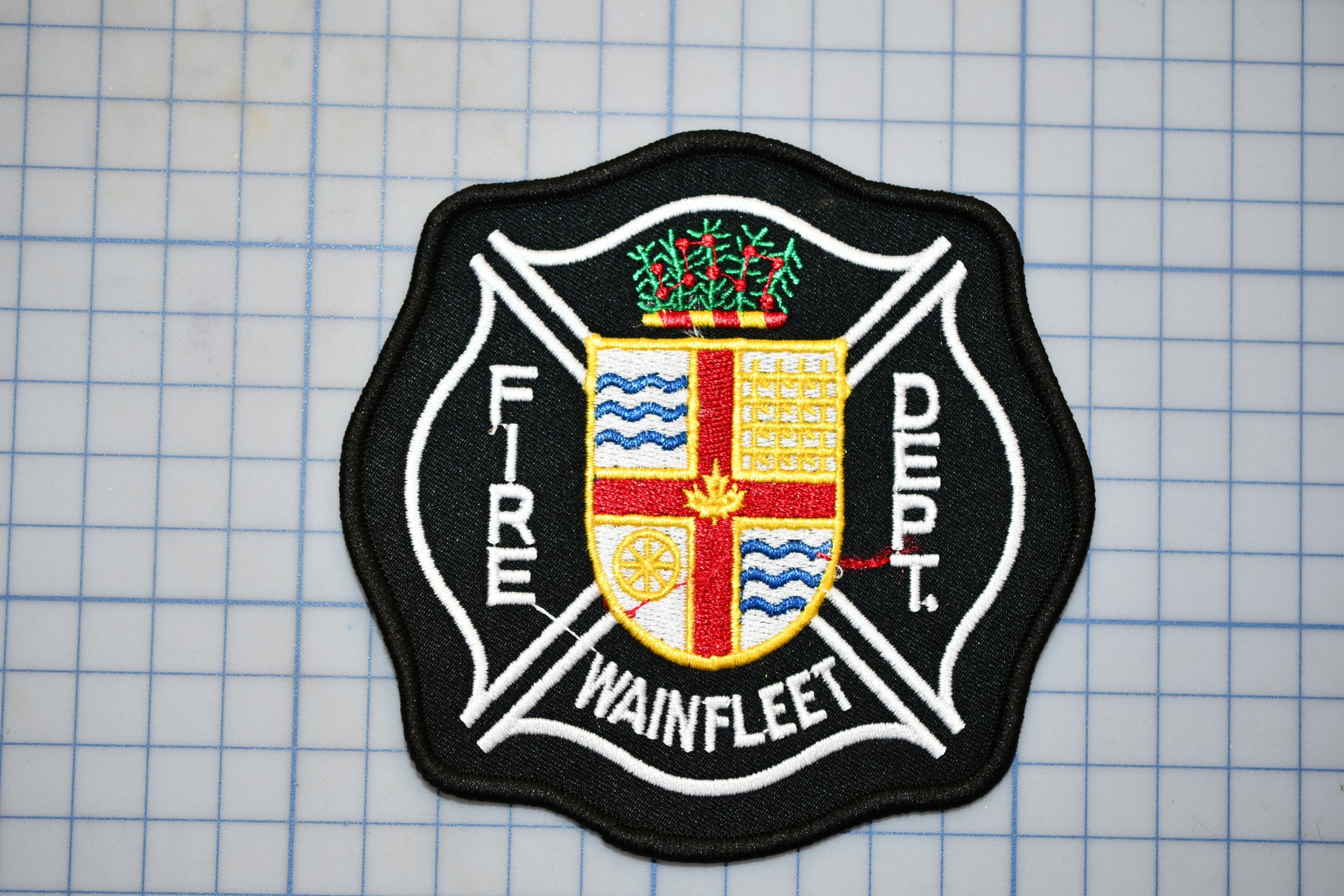 a fire department patch on a piece of paper