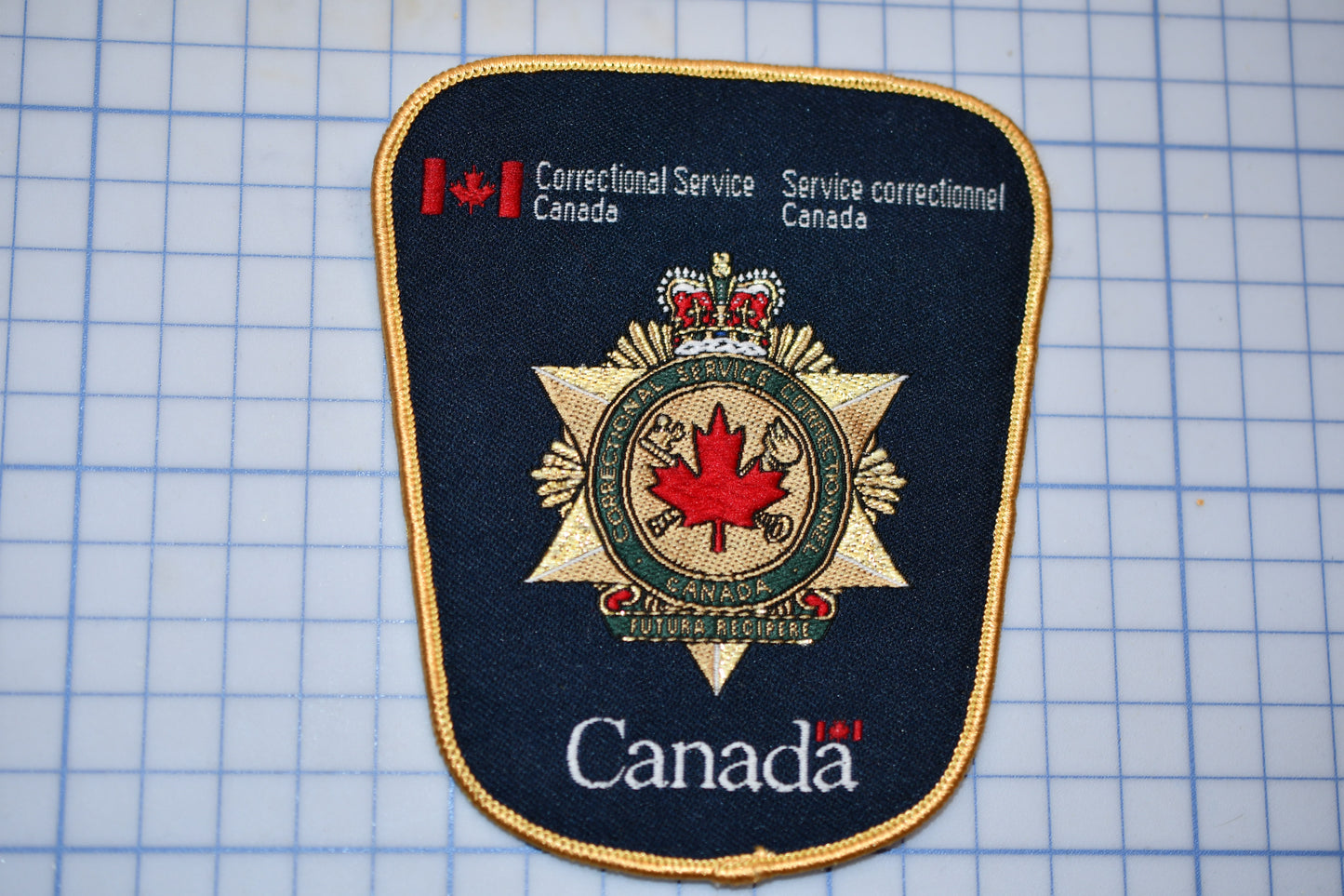 a canadian police patch on a cutting board