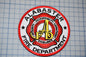 a red and white patch with a fire department logo