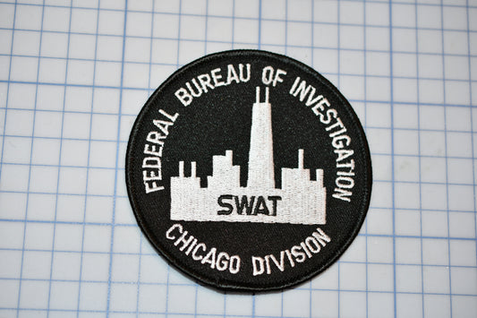 a black and white patch with a picture of a skyscraper