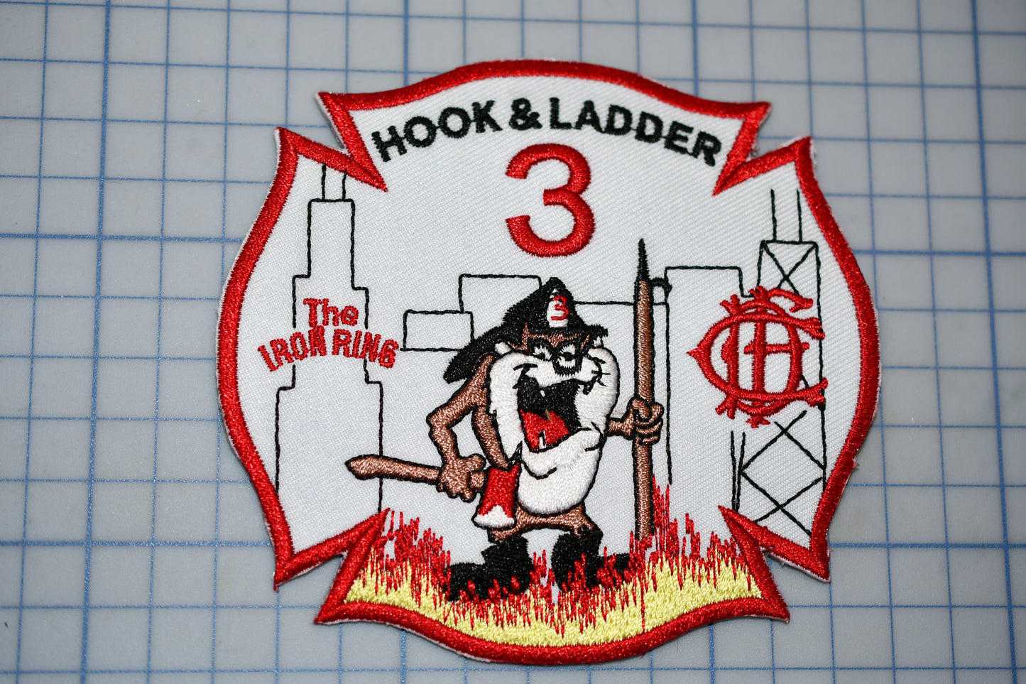 a patch with a fireman holding a fire hose