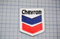 a chevron logo on a cutting board