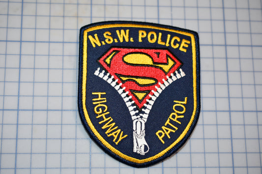 a police patch with a superman logo on it