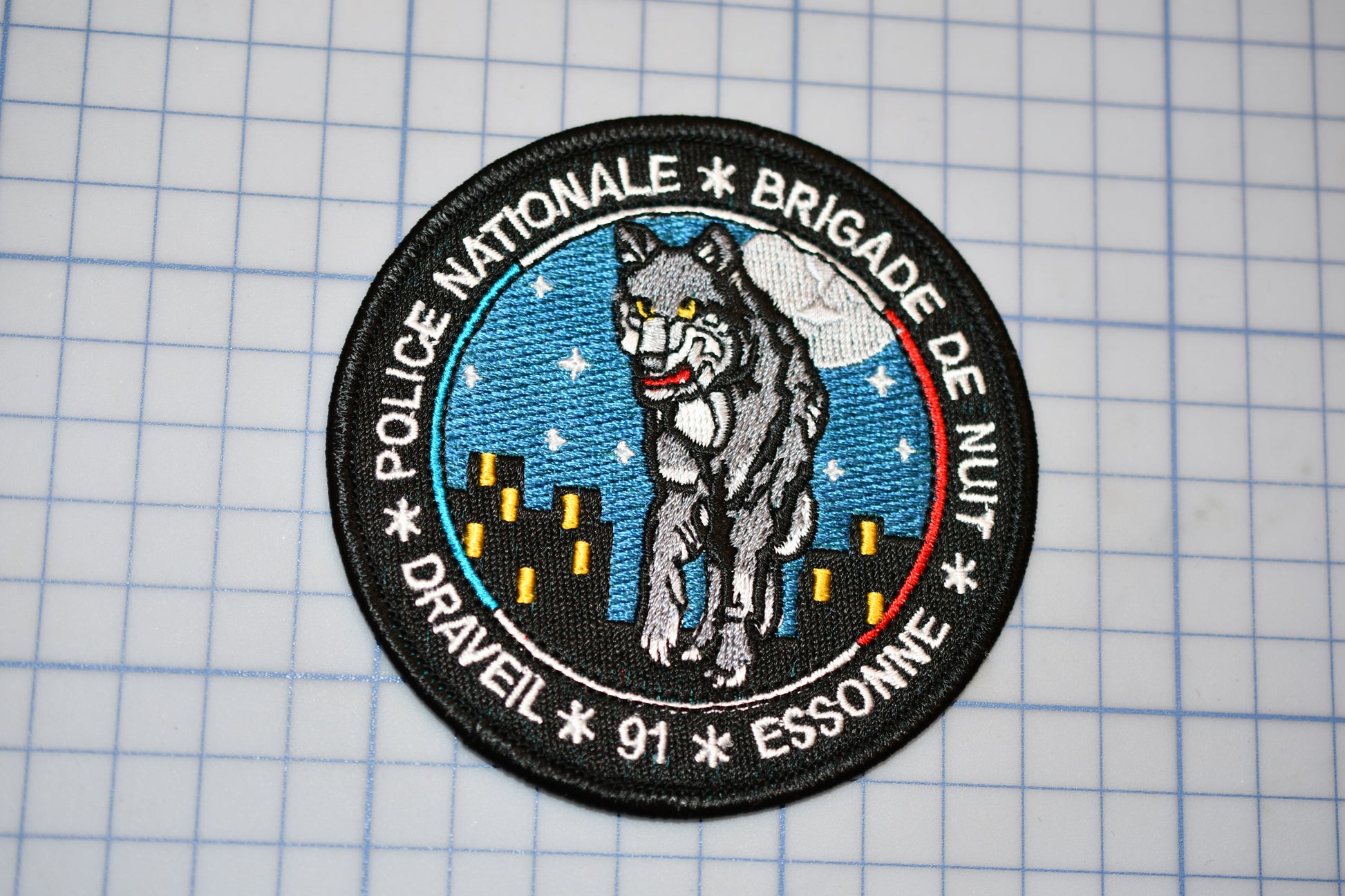 a patch with a picture of a wolf on it