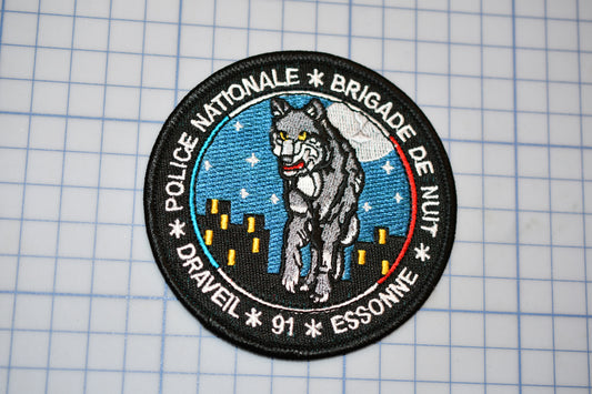 a patch with a picture of a wolf on it