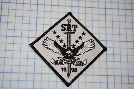 a patch with a sword and wings on it