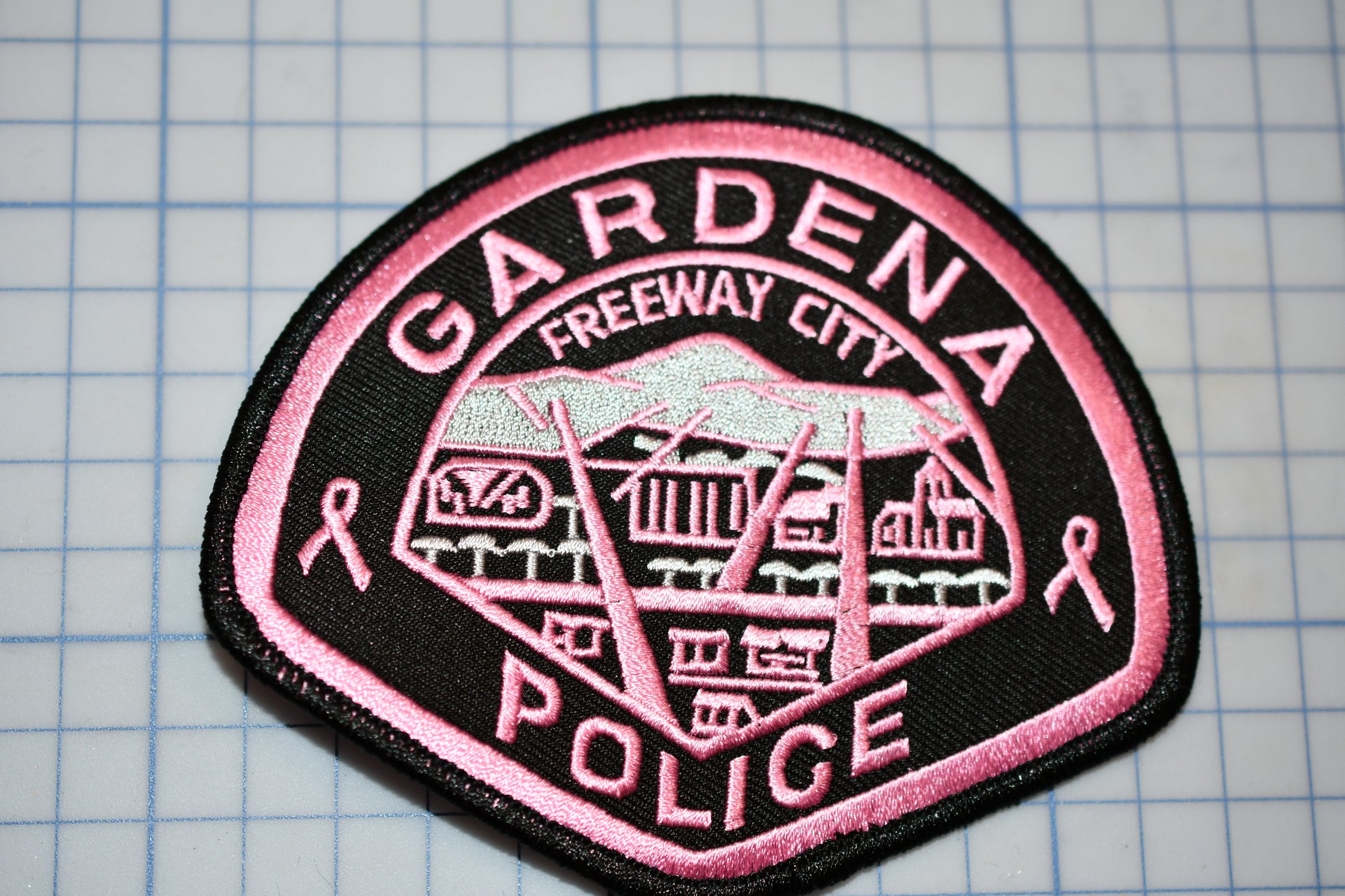 a pink and black patch with the words gardena freeway city police