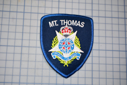 a blue patch with a crown on top of it