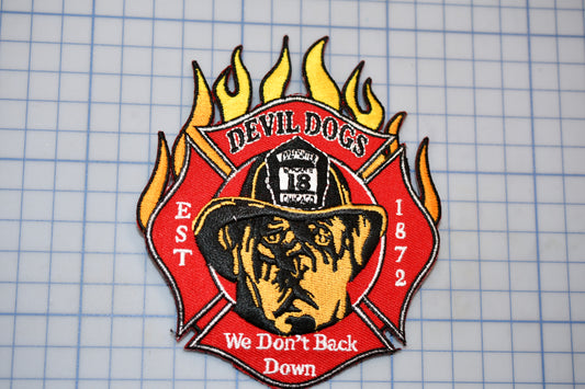 a fire department patch with a dog wearing a fireman's hat