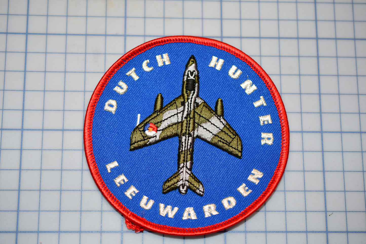 a patch with a picture of a fighter jet on it