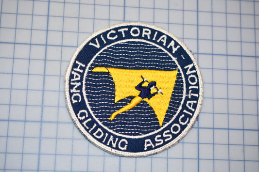 a blue and yellow patch with a yellow kite on it