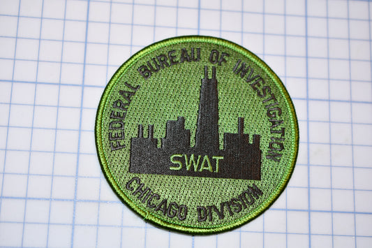 a green patch with a picture of a city on it