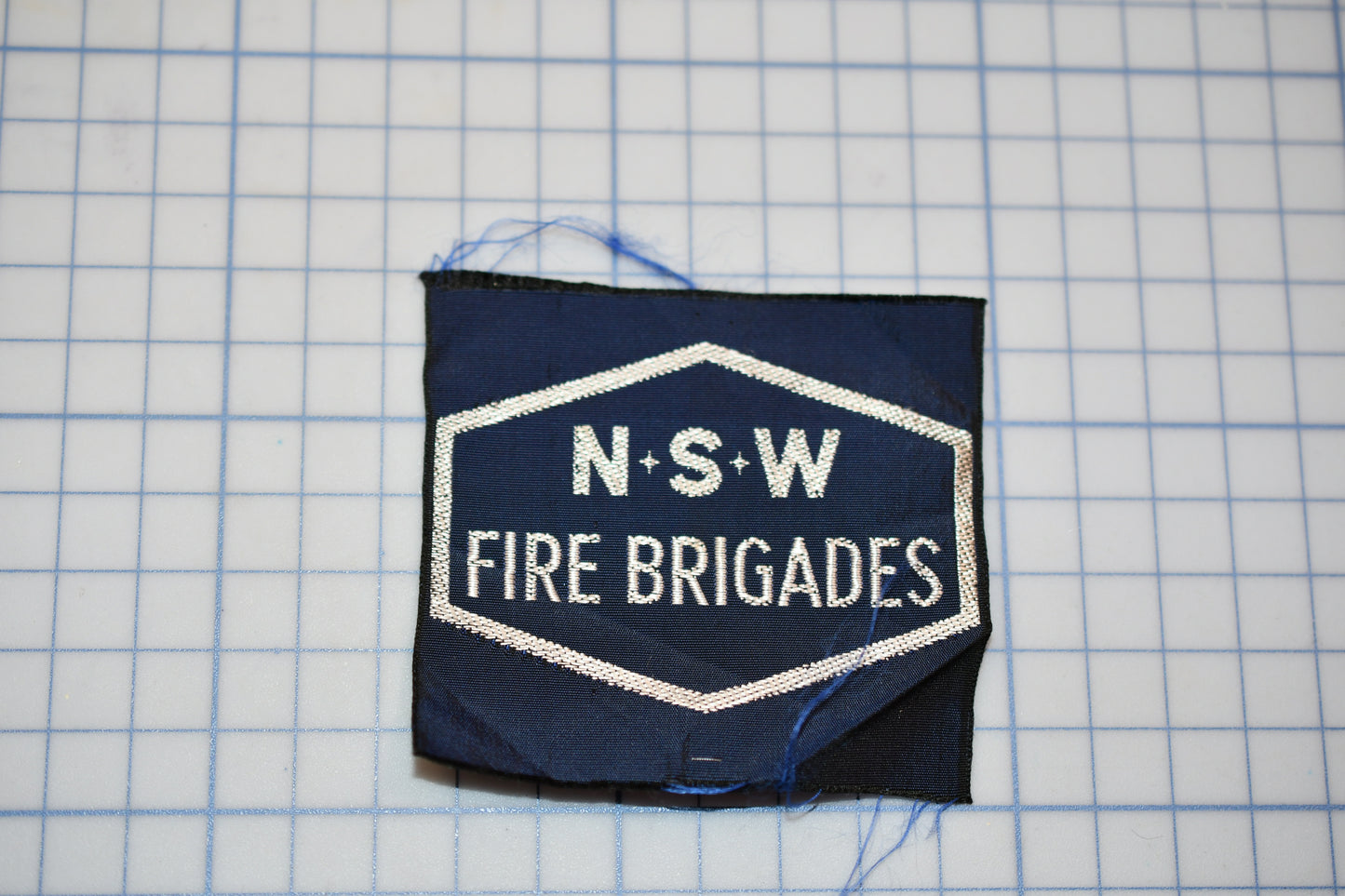 a piece of cloth with the words n s w fire brigade on it