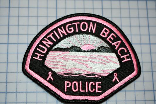 a pink and black patch that says huntington beach police