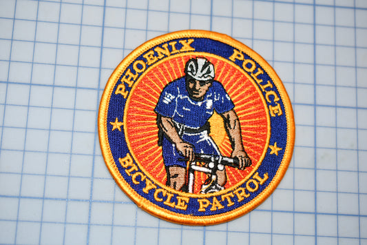 a patch with a picture of a man riding a bike