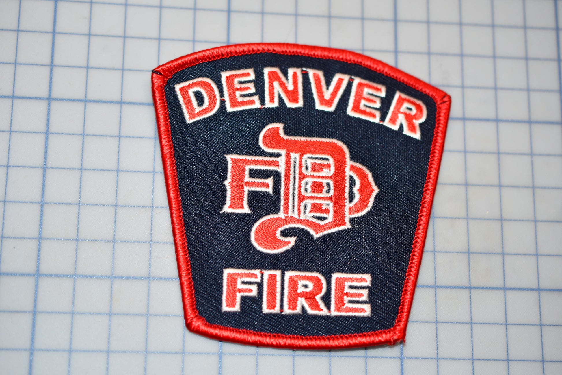 a red and blue patch with the words denver fire on it