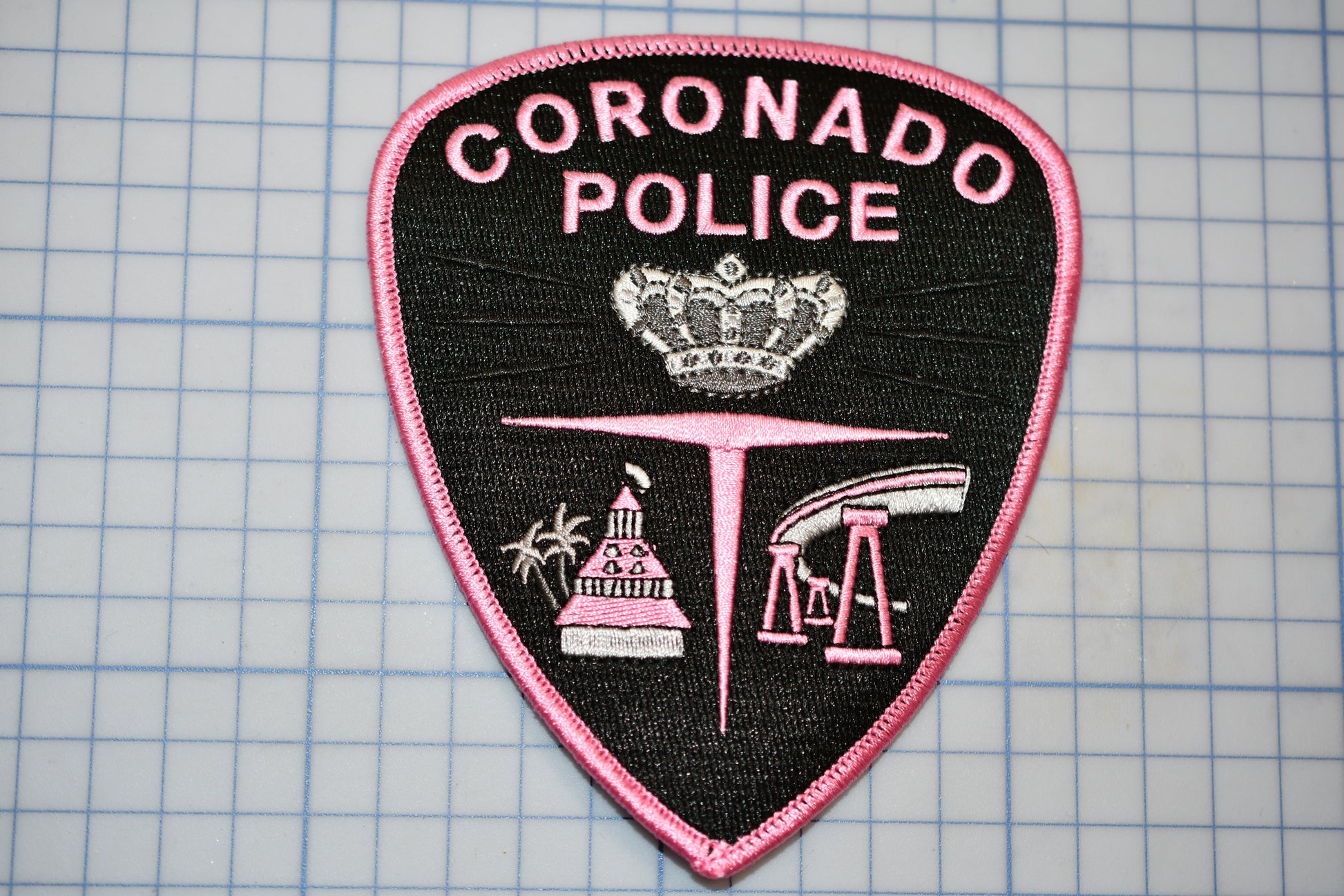 a police patch with the words coronado police on it