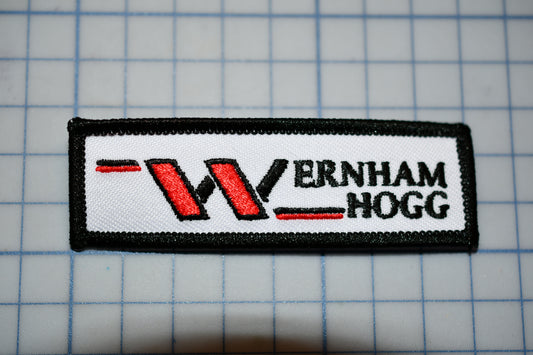 a white and black patch with a w logo on it