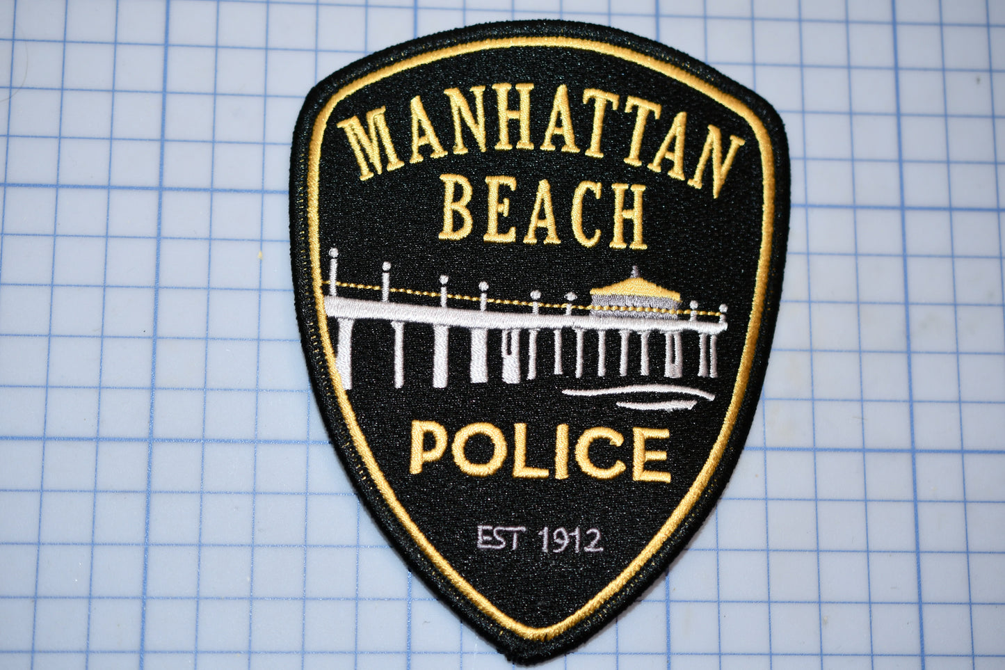 the manhattan beach police patch is on the table