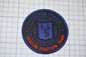 a patch with a blue and red logo on it