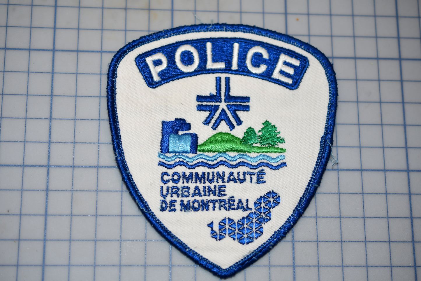 a police patch is shown on a cutting board