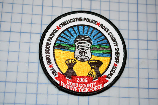 a patch with a picture of a man holding a baseball bat