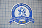 a blue and white patch with the words serving the community