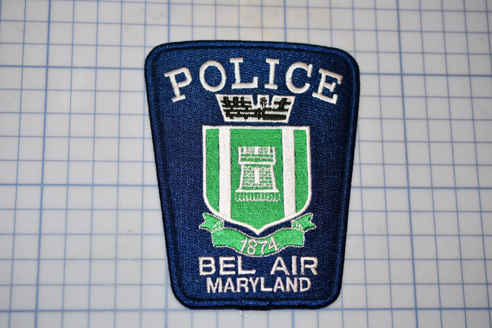 a police patch is shown on a cutting board