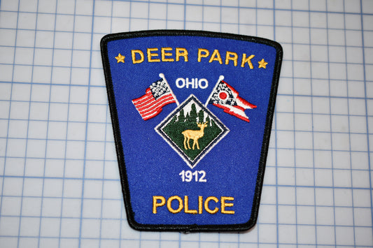 a patch with a deer and flag on it