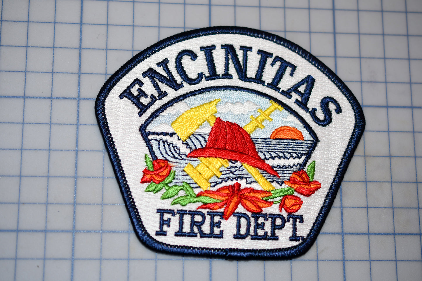 a fire department patch sitting on top of a piece of paper