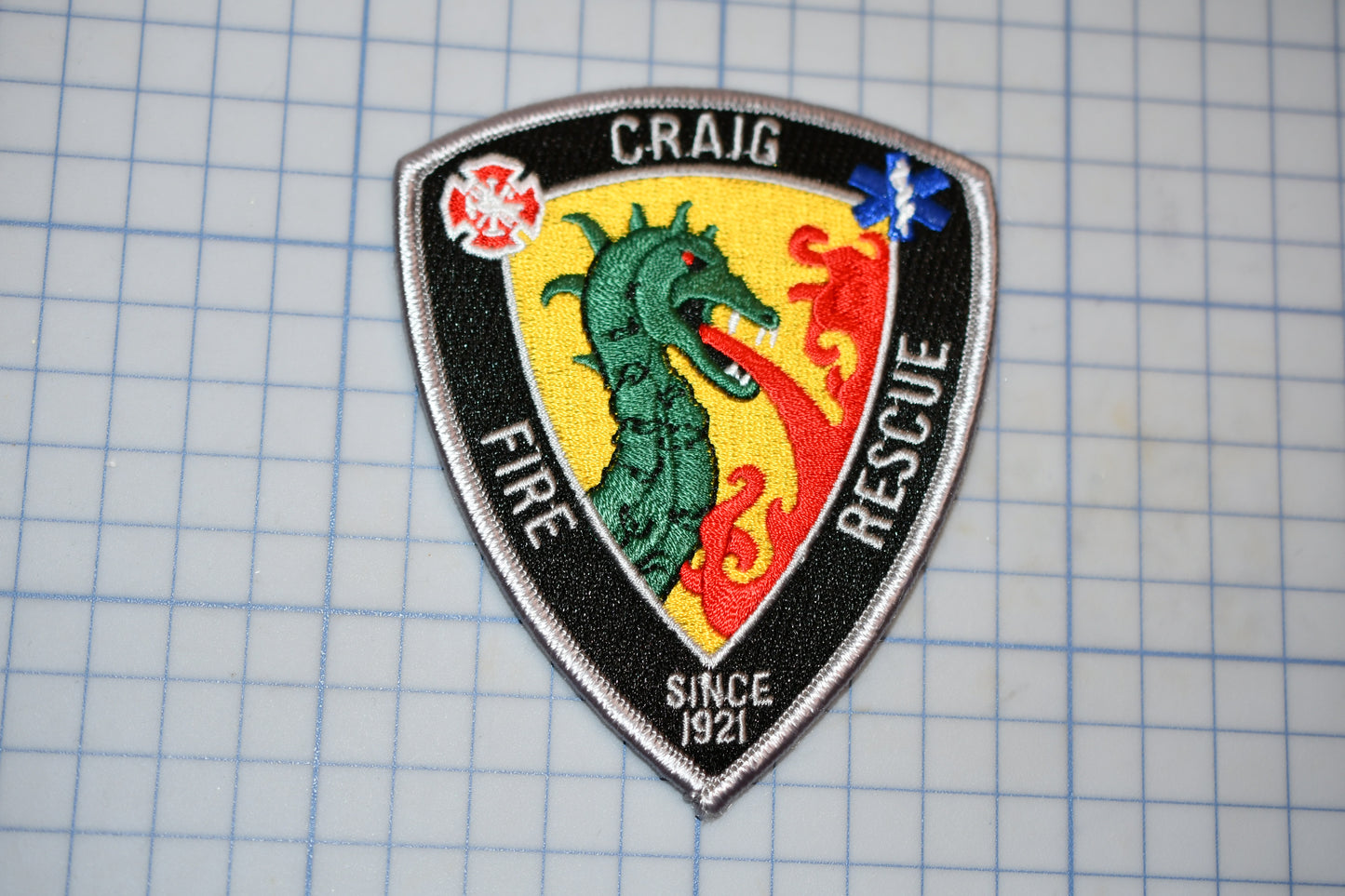 a patch with a picture of a dragon on it