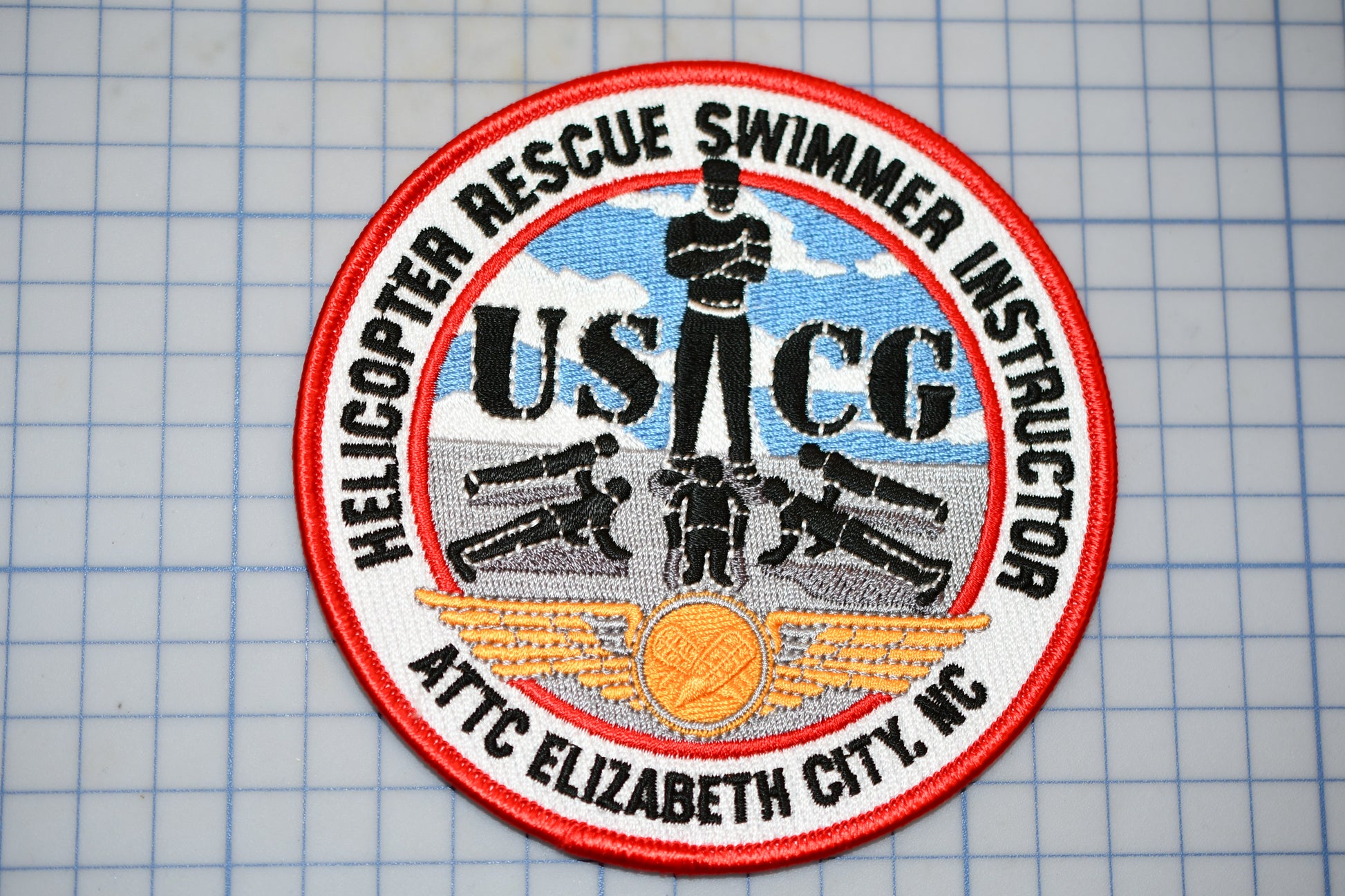 a patch with a picture of a man on a surfboard