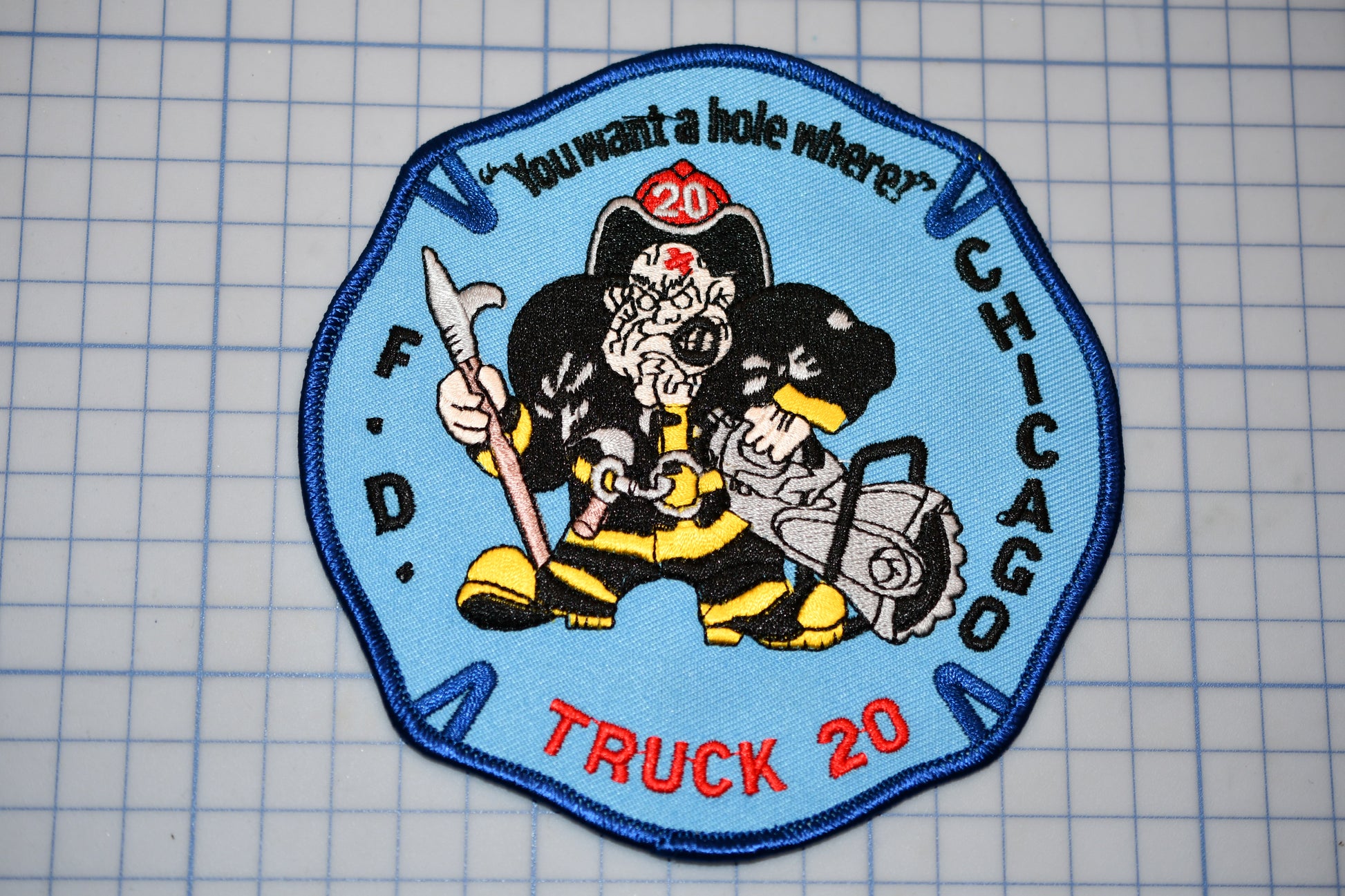 a patch with a fireman holding a chainsaw