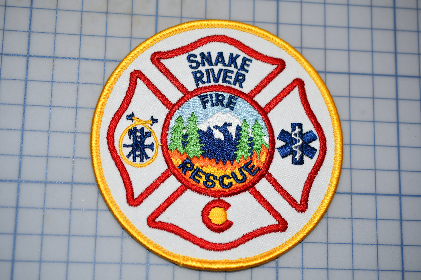 a snake river fire rescue patch on a cutting board