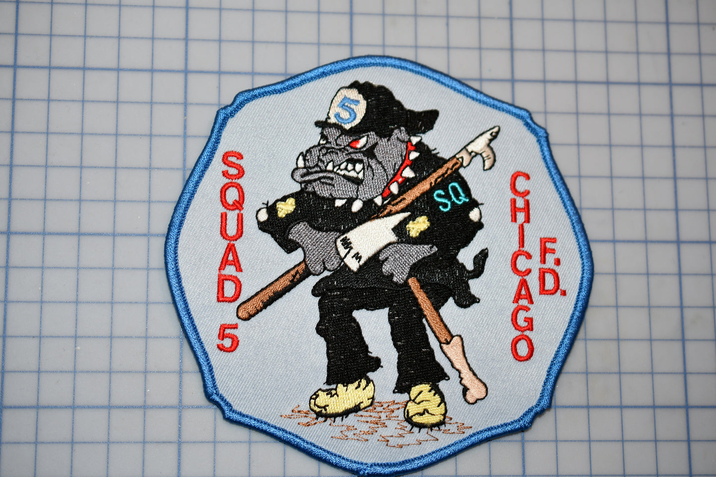 a patch with a picture of a dog holding a baseball bat