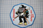 a patch with a picture of a dog holding a baseball bat