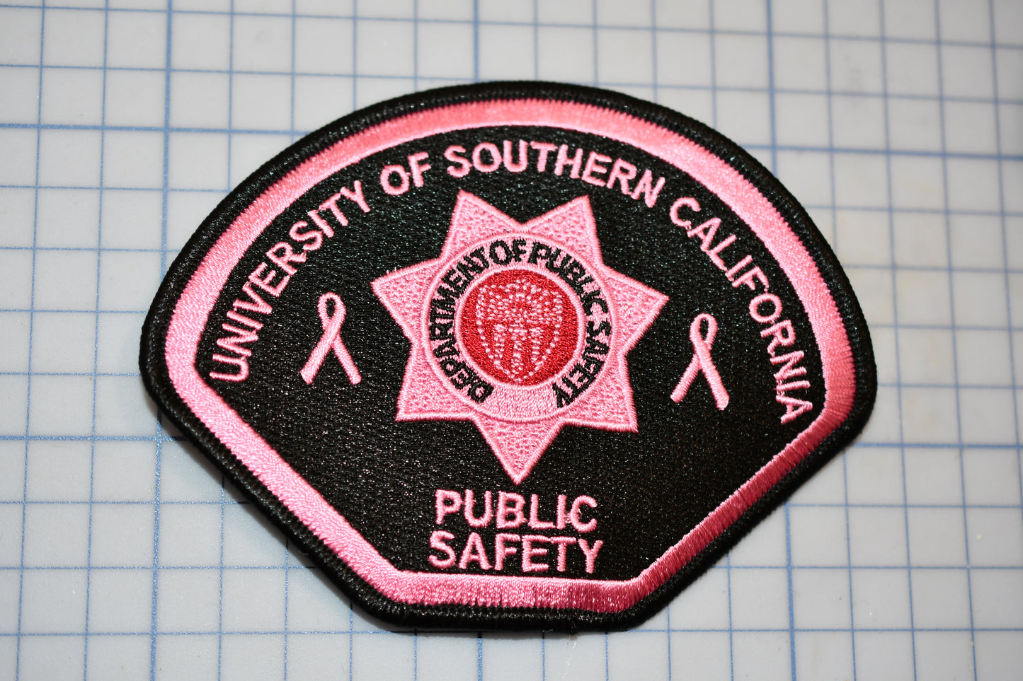 a pink and black patch with the words university of southern california on it