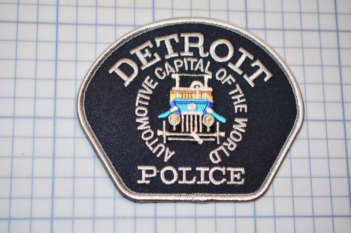 a detroit police patch sitting on top of a table